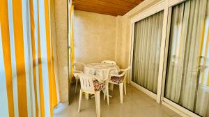 a small table and chairs on a balcony at Palatino Albir in Albir