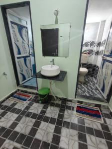 a bathroom with a sink and a mirror at Mahakal Homestay in Ujjain