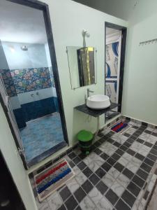 a bathroom with a sink and a shower at Mahakal Homestay in Ujjain