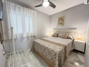 a bedroom with a bed and a window at PUSHE Playa Velilla Beach & Tradition 2 in Almuñécar