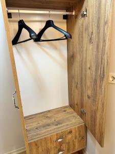 a closet with a wooden door and a shelf at pilot hotel in Arnavutköy
