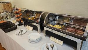 a buffet line with food on a table at Hotel Burrhus in Vaison-la-Romaine