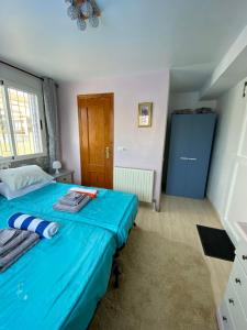 a bedroom with a blue bed and a blue cabinet at Ideal Location 3 Bed 3 Bath Villa With Pool On Camposol Sect B Close To Amenities in Mazarrón +37 photos