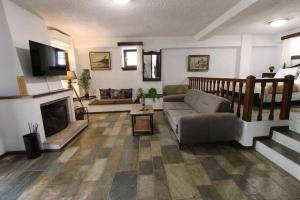 a living room with a couch and a fireplace at Raise Polydrosos Traditional Getaway in Polydrossos
