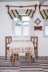 a table and two chairs in a room with a window at Casa Felicia in Suceviţa