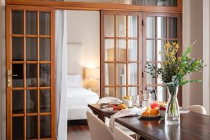 a dining room with a table with fruits and flowers at Porta Nuova Home Ravenna in Ravenna