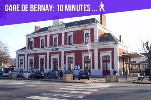 a large red building with cars parked in front of it at "Modern Cosy" Bernay hyper centre in Bernay