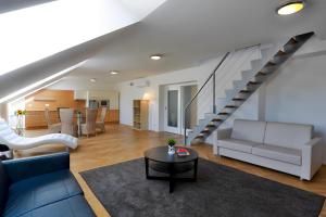 a living room with a couch and a table at James Hotel & Apartments in Prague