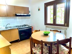 a kitchen with a wooden table with a bowl on it at La mia casa sul Pollino in San Lorenzo Bellizzi