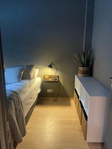 a bedroom with a bed and a table with a lamp at LL Properties - L19 Elegant Lux in Akureyri