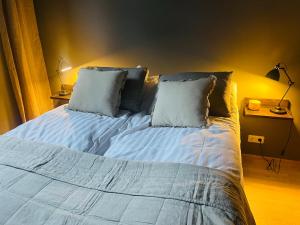 a bed with two pillows on it in a bedroom at LL Properties - L19 Elegant Lux in Akureyri