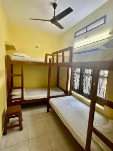 a room with two bunk beds and a window at Rams Gratitude Inn in Varkala