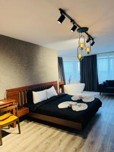 a bedroom with a large bed with a bath tub at Istanbul Airport Treekos Suite Hotel in Karaburun