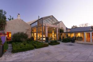 a large house with glass windows and a courtyard at Islington Hobart - Loft Suite - Australia in Hobart
