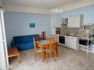 a kitchen and dining room with a table and chairs at MareFuori in Giardini Naxos