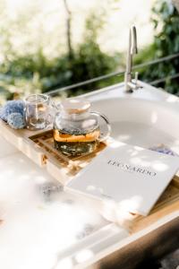 a tray with a jar of oil sitting on a sink at TwinHouse "Family Estate" in Kamianets-Podilskyi