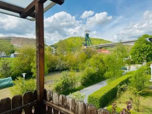 a view from a porch of a garden with a road at Silkes FeWo in Sollstedt