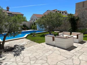 a backyard with a swimming pool and a villa at Villa Sania in Bol