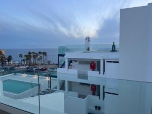 a building with a lighthouse on top of it at Albatros Apartments by Malibu in Callao Salvaje