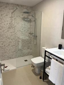 a bathroom with a shower and a toilet and a sink at Albatros Apartments by Malibu in Callao Salvaje