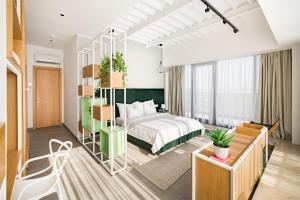 a hotel room with a bed and a room at Riva Mamaia Beach Apart Hotel in Mamaia