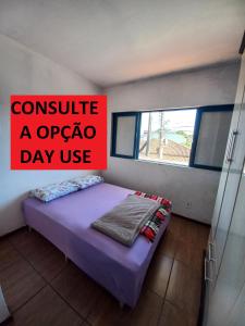 a bedroom with a sign that reads consult azonazona day use at Recanto Boa Vista in Joinville