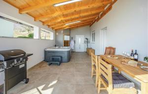 a kitchen and dining room with a table and a stove at Beautiful Home In Jastrebarsko in Jastrebarsko +28 photos