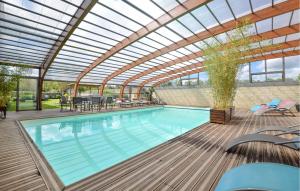 una piscina cubierta con techo de cristal y un patio en Gorgeous Home In Vienne-en-bessin With Private Swimming Pool, Can Be Inside Or Outside en Vienne-en-Bessin