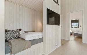 a bedroom with a white wall with a bed in it at 3 Bedroom Beautiful Home In Grenaa in Brøndstrup