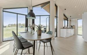 a kitchen and dining room with a table and chairs at 3 Bedroom Beautiful Home In Grenaa in Brøndstrup
