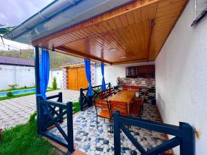a patio with a wooden pergola and a table and chairs at Gabala lux house in Gabala