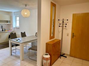 a kitchen and a dining room with a table and chairs at Schöne Wohnung in der Altstadt in Wangen im Allgäu