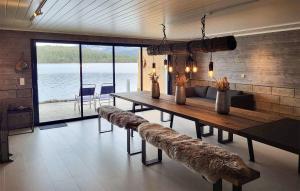 a dining room with a long wooden table and benches at Beautiful Home In Skodje With Wifi in Skodje