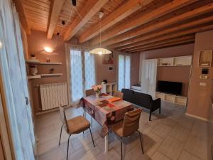 a living room with a dining room table and chairs at LA CASA DI ALICE in Lenno
