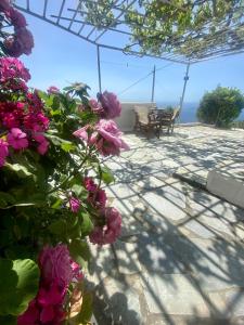 a patio with flowers and a view of the ocean at Margarita House 1 in Apróvaton