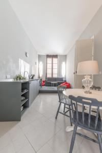 a kitchen and living room with a table and chairs at THE ARTIST'S LOFT in Valletta