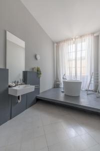 a bathroom with a tub and a sink and a counter at THE ARTIST'S LOFT in Valletta