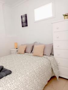 a bedroom with a bed and a white dresser at Amejica - Apartment with terrace and sea view in Tabaiba +21 photos