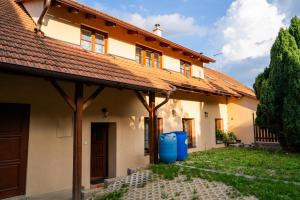 an old house with a rusty roof at Chalupa na Krakovci u Rakovníka in Krakovec