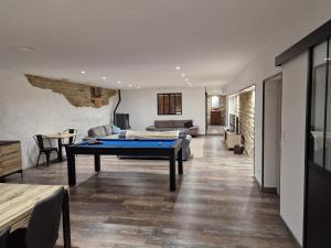 a living room with a ping pong table in it at UNE AUTRE MAISON Chambres d'hôtes in Pupillin