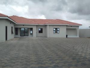 a large white house with a tile roof at Luxury 3 Bedroom Self Catering Apartment- Masvingo in Nyanda