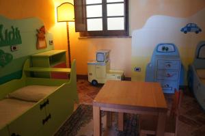 a room with a table and a bed and a desk at EcoResort Il Cantico della Natura in Magione