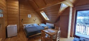 a small room with a bed and a table at Grazynka in Zakopane