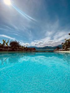 a large pool of blue water with a cloudy sky at Hotel Ideal in Malcesine