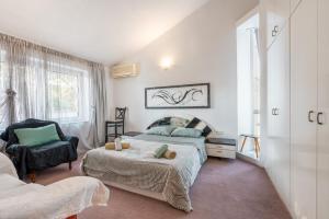 a bedroom with a bed and a chair at Artzy Villa in Rhodes Town +73 photos