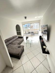 a living room with a couch and a large window at Grenoble ~ Ecole d’architecture ~ Grand-place in Grenoble