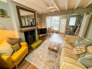 a living room with a couch and a table at CosyCottage, Log Fire&Garden in Mansfield