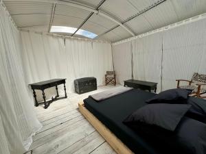a bedroom with a bed and a stove in a tent at Romantic Room in Antibes