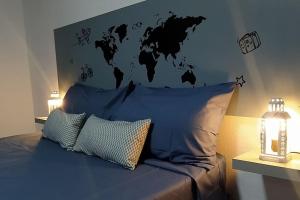 - une chambre avec un lit bleu et une carte du monde sur le mur dans l'établissement CASA MARY, Céntrico y amplio piso cerca del mar, en Candelaria, à Candelaria