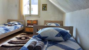 a bedroom with two beds and a window at Central Rustic House in Žabljak